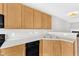 Well-lit kitchen features wooden cabinets, laminate countertops and black appliances at 2705 Wyntercrest Ln, Durham, NC 27713