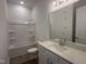 Cozy bathroom featuring a shower-tub combo, quartz countertop vanity, and a large mirror for a spa-like feel at 2874 Quarry Rd # 165, Rolesville, NC 27571