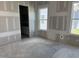 Unfinished bedroom with two windows and an open doorway to the en-suite bath, new construction at 2874 Quarry Rd # 165, Rolesville, NC 27571