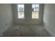 Bedroom featuring two windows for natural light and scenic views at 2874 Quarry Rd # 165, Rolesville, NC 27571