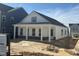 Charming white home featuring a welcoming front porch with stately columns and a mix of brick and siding details at 2874 Quarry Rd # 165, Rolesville, NC 27571