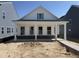 Charming white home with a covered porch and a brick foundation, new construction at 2874 Quarry Rd # 165, Rolesville, NC 27571