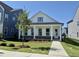 Inviting single-story home featuring a covered front porch, well-maintained lawn, and freshly planted tree at 2874 Quarry Rd # 165, Rolesville, NC 27571