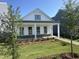 Beautiful white single-story home with a covered porch, manicured lawn, and an inviting entryway at 2874 Quarry Rd # 165, Rolesville, NC 27571