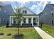 Inviting single-Gathering home featuring a classic facade, covered porch, and manicured lawn at 2874 Quarry Rd # 165, Rolesville, NC 27571