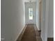 View of hallway that leads to the front door with wood floors at 2874 Quarry Rd # 165, Rolesville, NC 27571