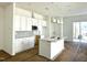 Bright, modern kitchen featuring white cabinets, a central island, stylish pendant lighting, and stainless steel appliances at 2874 Quarry Rd # 165, Rolesville, NC 27571