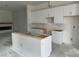 A kitchen with white cabinets, center island, and modern design elements at 2874 Quarry Rd # 165, Rolesville, NC 27571