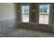 Unfinished living room with ample natural light from two large windows overlooking the outdoors at 2874 Quarry Rd # 165, Rolesville, NC 27571