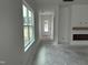 Bright, unfinished living room with large windows and fireplace mantel ready for customization at 2874 Quarry Rd # 165, Rolesville, NC 27571
