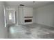 Spacious, unfinished living room with a fireplace and mantel awaiting personal touches at 2874 Quarry Rd # 165, Rolesville, NC 27571