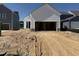 Rear of the home featuring an unfinished yard, garage, and sliding glass door at 2874 Quarry Rd # 165, Rolesville, NC 27571