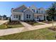 New construction home with light grey and white facade, front yard, and green door at 2911 Alyssa Ct, Raleigh, NC 27604