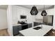 Modern kitchen features white cabinets, gray island, stainless steel appliances, and stylish pendant lighting at 2911 Alyssa Ct, Raleigh, NC 27604