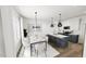 Open-concept kitchen and dining area featuring a large island with bar stools and a dining table at 2911 Alyssa Ct, Raleigh, NC 27604