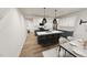 Open-concept kitchen with island seating, modern lighting, and stainless steel appliances at 2915 Alyssa Ct, Raleigh, NC 27604