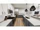 Modern kitchen with stainless steel appliances, white cabinets, and a spacious island with a sink at 2915 Alyssa Ct, Raleigh, NC 27604