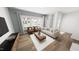 Bright living room with large windows, hardwood floors, and comfortable seating arrangement at 2915 Alyssa Ct, Raleigh, NC 27604