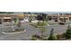 Aerial view of a shopping center with various storefronts, ample parking, and green landscaping at 312 Calvander Ln, Apex, NC 27539