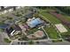 Aerial view of the community pool, playground, parking area, and surrounding lush greenery at 312 Calvander Ln, Apex, NC 27539