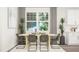 Inviting dining area with a wooden table, comfortable seating, and modern accents at 312 Calvander Ln, Apex, NC 27539