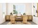 Bright home office with a wooden desk, cabinets, and a large window showcasing the outdoors at 312 Calvander Ln, Apex, NC 27539