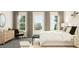 Serene bedroom with large windows, a bench at the foot of the bed, and a calming atmosphere at 312 Calvander Ln, Apex, NC 27539