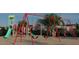 Community playground with swings, slides, and a climbing structure providing a safe space for play and exercise at 312 Calvander Ln, Apex, NC 27539