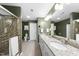 Spacious bathroom featuring a granite countertop double vanity and a glass-enclosed tiled shower at 322 Brier Crossings Loop, Durham, NC 27703