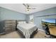 Bedroom featuring light blue walls, a ceiling fan, and an office space at 322 Brier Crossings Loop, Durham, NC 27703