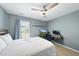 Bedroom featuring light blue walls, a ceiling fan, and an office space at 322 Brier Crossings Loop, Durham, NC 27703