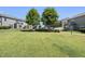 Green lawn between townhomes has trees and benches, offering tranquil outdoor community space at 322 Brier Crossings Loop, Durham, NC 27703