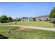 Open green lawn in a townhome community offering a walking path and outdoor space at 322 Brier Crossings Loop, Durham, NC 27703