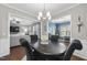 Inviting dining area with a modern chandelier, opening up to the living room and office at 322 Brier Crossings Loop, Durham, NC 27703
