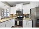 Modern kitchen with granite countertops, stainless steel appliances, and white cabinetry at 322 Brier Crossings Loop, Durham, NC 27703
