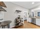 Cozy kitchen area with wooden floors, a wine rack, and views into the dining and living spaces at 322 Brier Crossings Loop, Durham, NC 27703