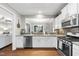 Bright kitchen with white cabinets, stainless steel appliances, and granite countertops at 322 Brier Crossings Loop, Durham, NC 27703