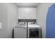 Laundry room with a front load washer and dryer and overhead cabinets at 322 Brier Crossings Loop, Durham, NC 27703
