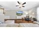 Open-concept living room with hardwood floors, modern furnishings, and a ceiling fan at 322 Brier Crossings Loop, Durham, NC 27703