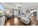 Bright living room featuring hardwood floors, a ceiling fan, and a comfortable seating area at 322 Brier Crossings Loop, Durham, NC 27703