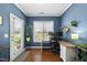 Well-lit office space features desk, shelves, and a view of the outdoors at 322 Brier Crossings Loop, Durham, NC 27703