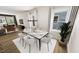 Elegant dining room open to the living room, with a modern chandelier and ample seating at 332 Cottage Hl, Knightdale, NC 27604