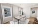 Bright dining room with a stylish chandelier and seating for six at 332 Cottage Hl, Knightdale, NC 27604
