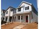Charming new construction home with white siding, black shutters, and a vibrant red front door at 332 Cottage Hl, Knightdale, NC 27604
