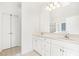 Bright bathroom featuring double sinks, a large mirror, and tile flooring at 3404 Apple Meadow Dr, Fuquay Varina, NC 27526
