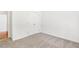 Clean, neutral bedroom with light gray carpet and closet with double doors at 3404 Apple Meadow Dr, Fuquay Varina, NC 27526