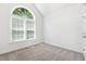 Bright bedroom featuring a large arched window and neutral carpet at 3404 Apple Meadow Dr, Fuquay Varina, NC 27526