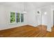Bright dining area boasts hardwood floors, a modern chandelier, and large windows at 3404 Apple Meadow Dr, Fuquay Varina, NC 27526