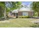 Well-maintained brick home with manicured lawn and mature trees on a sunny day at 3404 Apple Meadow Dr, Fuquay Varina, NC 27526