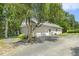 Detached garage with a large driveway and mature trees at 3404 Apple Meadow Dr, Fuquay Varina, NC 27526